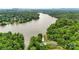 Breathtaking aerial perspective showcasing the property nestled amidst lush greenery along the lake at 6294 Southlake Dr, Hickory, NC 28601