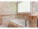 Bathroom with tiled walls, a deep soaking tub, and a stylish faucet at 6294 Southlake Dr, Hickory, NC 28601