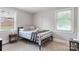 This is a light-filled bedroom with modern gray walls, bright windows, and wall decor at 6294 Southlake Dr, Hickory, NC 28601