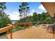 View from the deck overlooking trees and lake, with chairs, and wooden railings at 6294 Southlake Dr, Hickory, NC 28601