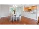 Elegant dining room with hardwood floors, a chandelier, and a view of the kitchen and living room at 6294 Southlake Dr, Hickory, NC 28601