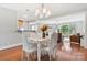 Inviting dining area with hardwood floors, chandelier, and an open layout connecting to the living room and kitchen at 6294 Southlake Dr, Hickory, NC 28601