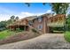Brick home with wood deck, ground-level covered parking and a winding driveway at 6294 Southlake Dr, Hickory, NC 28601
