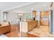 Well-lit kitchen with wooden cabinetry, granite countertops, tile backsplash, and an open view to the dining and living areas at 6294 Southlake Dr, Hickory, NC 28601