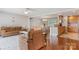 Inviting living room featuring hardwood floors, leather seating, and an open floor plan to the kitchen and dining area at 6294 Southlake Dr, Hickory, NC 28601