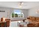 Bright, open living room with hardwood floors, a ceiling fan, and lake views from a large window at 6294 Southlake Dr, Hickory, NC 28601