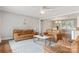 Comfortable living room with hardwood floors, leather furniture, a modern coffee table, and access to the dining area at 6294 Southlake Dr, Hickory, NC 28601