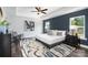 Spacious primary bedroom featuring a modern color palette, ceiling fan, large windows, and stylish decor at 718 Lithia Inn Rd, Lincolnton, NC 28092