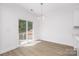 Bright dining area with wood-look flooring, sliding glass doors, and minimalist chandelier at 722 Lithia Inn Rd, Lincolnton, NC 28092