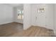 Bright entryway featuring wood-look flooring, white walls, a window, and a paneled front door at 722 Lithia Inn Rd, Lincolnton, NC 28092