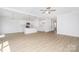 Bright open-concept kitchen and living space with white cabinets and wood-look flooring at 722 Lithia Inn Rd, Lincolnton, NC 28092