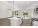 Open living space and kitchen featuring a kitchen island, large windows, and stainless appliances at 722 Lithia Inn Rd, Lincolnton, NC 28092