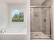 Bathroom featuring a garden tub and separate glass shower at 726 Lithia Inn Rd, Lincolnton, NC 28092