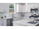 Bright, modern kitchen with white cabinetry, stainless steel appliances, and ample counter space at 726 Lithia Inn Rd, Lincolnton, NC 28092