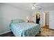Bedroom with a patterned bedspread, wood floors, walk-in closet, and ensuite bathroom at 7671 Bluff Point Ln, Denver, NC 28037