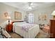 Charming bedroom with a ceiling fan, floral decor, and ample natural light at 7671 Bluff Point Ln, Denver, NC 28037