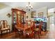 Inviting dining area featuring a wooden table, chairs, china cabinet, and decorative accents at 7671 Bluff Point Ln, Denver, NC 28037