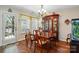 Traditional dining room with hardwood floors, wooden furniture, chandelier, and natural light at 7671 Bluff Point Ln, Denver, NC 28037