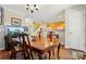 Open dining space with wood floors, table and chairs next to the kitchen and staircase at 7671 Bluff Point Ln, Denver, NC 28037