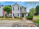 Attractive two-story townhome with well-manicured landscaping and a welcoming entrance at 7671 Bluff Point Ln, Denver, NC 28037