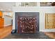 Detailed view of a decorative fireplace with a metal fire screen, adding character and charm to the living space at 7671 Bluff Point Ln, Denver, NC 28037