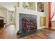 Close-up of a fireplace with a decorative metal fire screen and view of the front entry at 7671 Bluff Point Ln, Denver, NC 28037