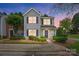 Charming two-story home with gray siding, black shutters, and a well-manicured front yard at 7671 Bluff Point Ln, Denver, NC 28037
