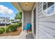 Inviting front porch with blue chair at 7671 Bluff Point Ln, Denver, NC 28037