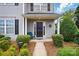 Inviting front porch with blue chair and decorative landscaping for added curb appeal at 7671 Bluff Point Ln, Denver, NC 28037