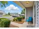 Inviting front porch with blue chair at 7671 Bluff Point Ln, Denver, NC 28037