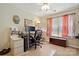 Well-lit office featuring a large desk, storage, a ceiling fan, and stylish décor at 7671 Bluff Point Ln, Denver, NC 28037