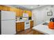 A well-lit kitchen with white appliances and ample cabinet space at 7671 Bluff Point Ln, Denver, NC 28037
