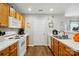 This well-lit kitchen features white countertops, wood cabinets and white appliances at 7671 Bluff Point Ln, Denver, NC 28037