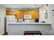 Kitchen with white countertops, wooden cabinets, and appliances, showcasing a functional layout at 7671 Bluff Point Ln, Denver, NC 28037