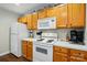 Functional kitchen with white appliances and wooden cabinets at 7671 Bluff Point Ln, Denver, NC 28037