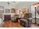 Cozy living room featuring comfortable chairs, fireplace and large windows for natural light at 7671 Bluff Point Ln, Denver, NC 28037