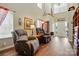 Spacious living room with hardwood floors and comfortable seating at 7671 Bluff Point Ln, Denver, NC 28037