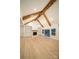 Spacious living room with fireplace, wood beams, built-in bookshelves, hardwood floors, and sliding glass doors at 770 Highway 274 Rd, Clover, SC 29710