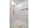 Luxurious shower with marble tiling, pebble floor, rainfall shower head, and built in shelving at 770 Highway 274 Rd, Clover, SC 29710