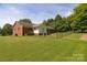 Spacious backyard with well-maintained lawn, fencing, and lush green trees, great for outdoor activities at 7869 Cherry Point Dr, Denver, NC 28037