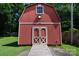 Exterior front view of a barn, showcasing its wooden structure, double doors and plank walkway at 7869 Cherry Point Dr, Denver, NC 28037