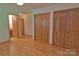 Bedroom featuring hardwood floors and multiple closets for ample storage space at 7869 Cherry Point Dr, Denver, NC 28037