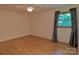 Bright bedroom with hardwood floors and natural light from the large window at 7869 Cherry Point Dr, Denver, NC 28037