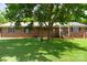 Charming brick home featuring a well-maintained lawn and mature tree offering plenty of shade at 7869 Cherry Point Dr, Denver, NC 28037
