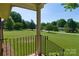 Porch view overlooking beautifully kept front yard and neighborhood trees; scenic setting at 7869 Cherry Point Dr, Denver, NC 28037