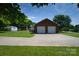 Detached two-car garage with a large driveway and additional parking space in backyard at 7869 Cherry Point Dr, Denver, NC 28037