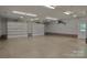 Spacious garage with high ceilings, brick accents, and ample lighting at 7869 Cherry Point Dr, Denver, NC 28037