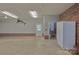 Spacious garage with brick accents and door leading to a bathroom at 7869 Cherry Point Dr, Denver, NC 28037