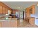 Well-lit kitchen featuring wooden cabinets, granite countertops, and stainless steel appliances at 7869 Cherry Point Dr, Denver, NC 28037
