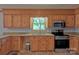 Well-lit kitchen showcases wooden cabinets, stainless steel appliances and outdoor view at 7869 Cherry Point Dr, Denver, NC 28037